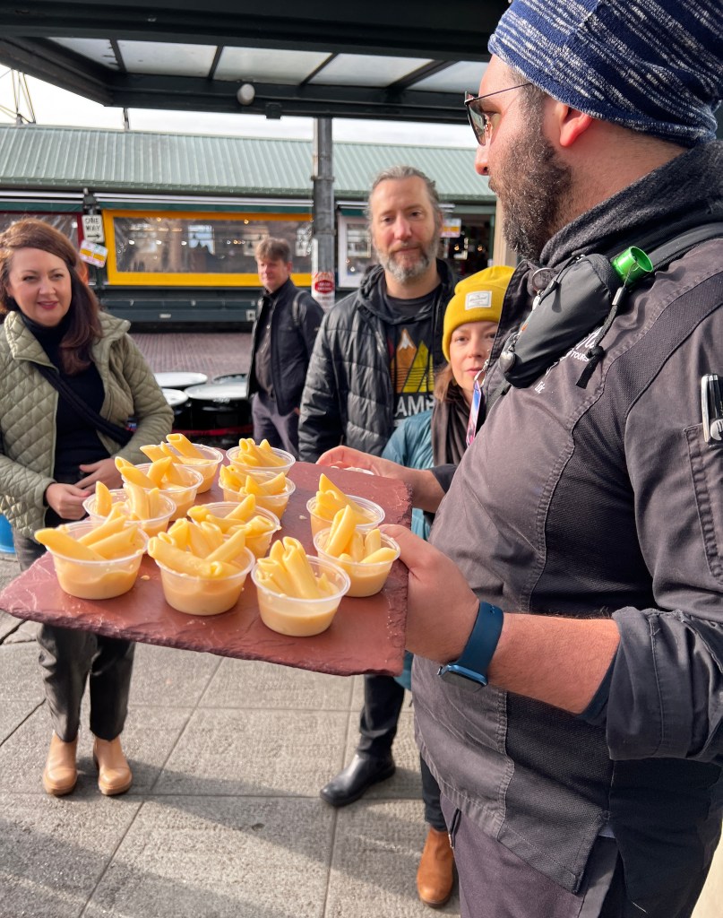 Chef Eric Olinsky giving samples of Beecher's Mac and Cheese during one of his Viator culinary tours of Seattle.