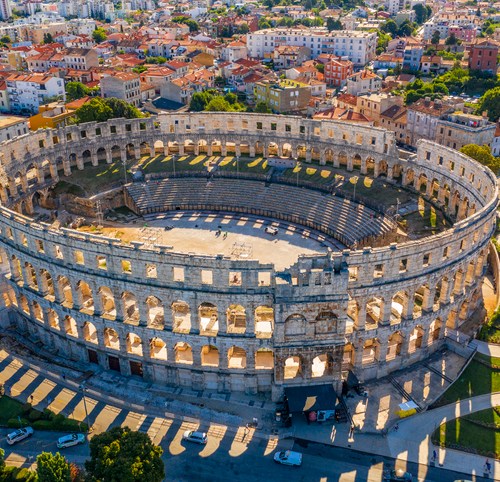 Aerial view of Pula Arena, Croatia. Pula is a living museum of the past with many well-preserved Roman ruins. iStock.com/xbrchx