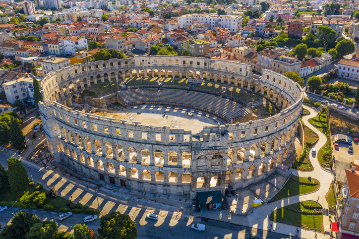 Aerial view of Pula Arena, Croatia. Pula is a living museum of the past with many well-preserved Roman ruins. iStock.com/xbrchx